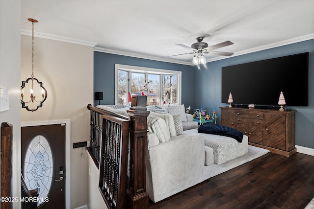 living room featuring dark wood-type flooring, crown molding, and ceiling fan with notable chandelier