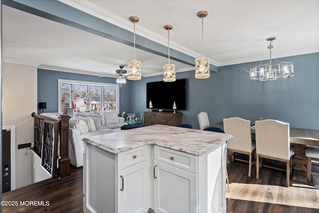 kitchen featuring white cabinetry, dark hardwood / wood-style floors, pendant lighting, and light stone counters