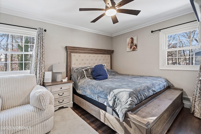 bedroom with dark hardwood / wood-style flooring, crown molding, and ceiling fan