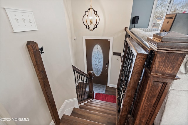 entrance foyer with dark wood-type flooring and a notable chandelier