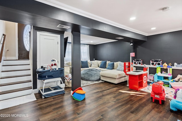 rec room with dark hardwood / wood-style flooring and ornamental molding