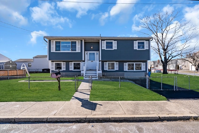 bi-level home with a fenced front yard, a gate, and a front yard