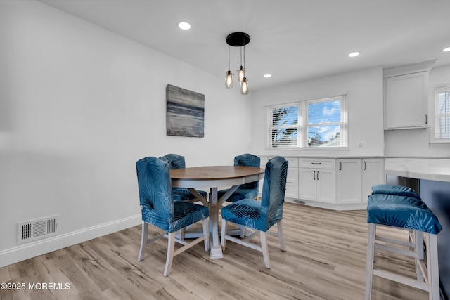 dining room with recessed lighting, baseboards, visible vents, and light wood-type flooring