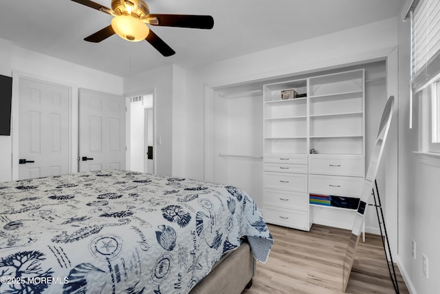 bedroom featuring a closet, ceiling fan, and light wood finished floors