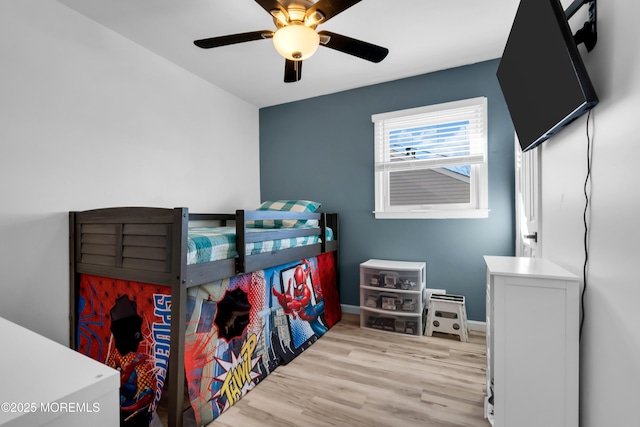 bedroom featuring a ceiling fan, wood finished floors, and baseboards