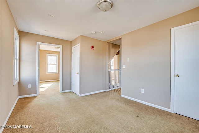 spare room featuring light colored carpet