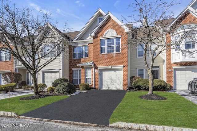 townhome / multi-family property featuring a garage and a front yard