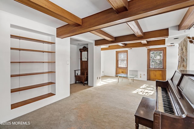 miscellaneous room with built in shelves, light colored carpet, and beamed ceiling