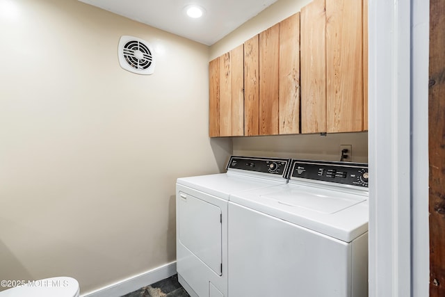 laundry area with separate washer and dryer and cabinets