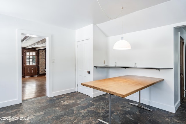 unfurnished dining area with beamed ceiling