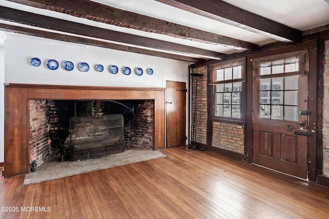 interior space with wood-type flooring and beam ceiling