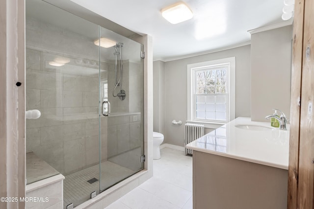 bathroom with ornamental molding, radiator heating unit, toilet, and vanity