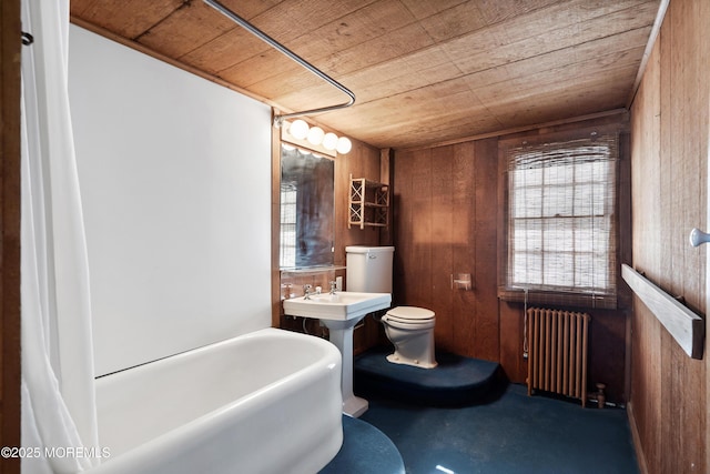 bathroom with wood ceiling, radiator heating unit, and wooden walls