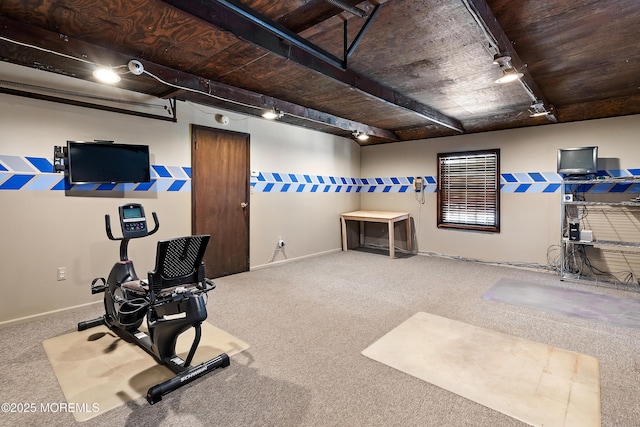 workout room featuring track lighting, carpet flooring, and wooden ceiling