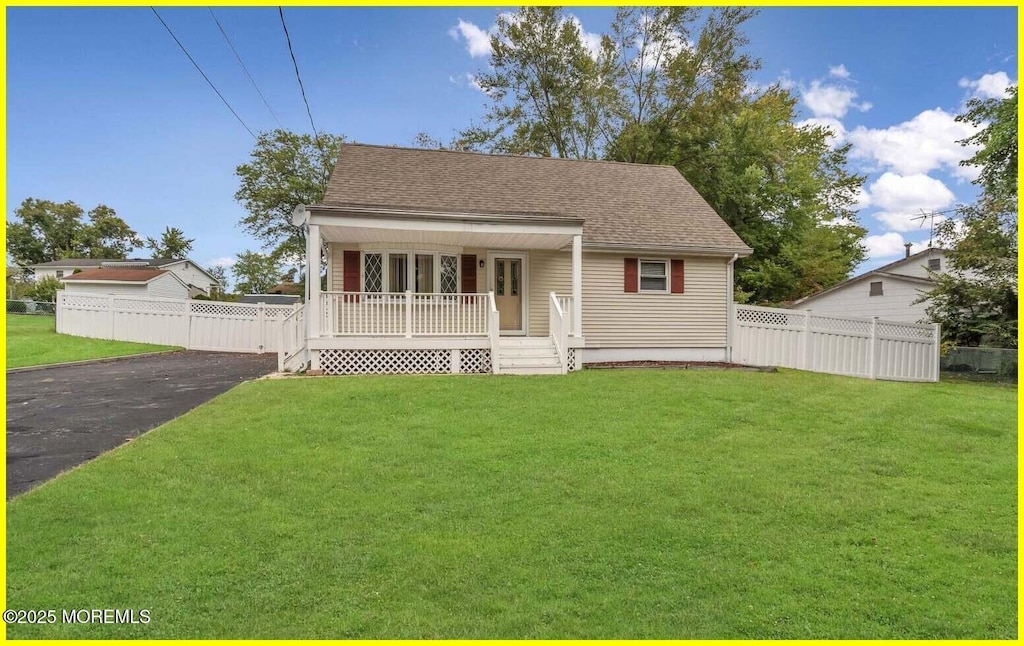 view of front of home with a front yard and covered porch