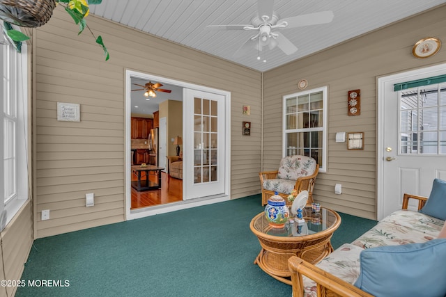 sunroom / solarium featuring ceiling fan