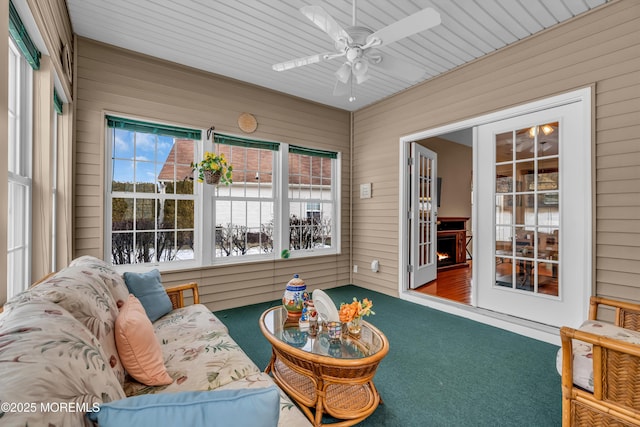 sunroom / solarium featuring ceiling fan