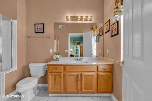 bathroom with tile patterned flooring, vanity, walk in shower, and toilet