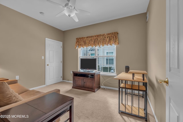 carpeted living room with ceiling fan