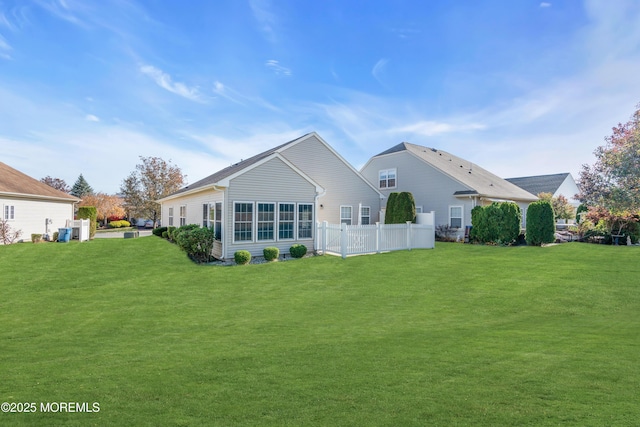 back of house featuring a lawn