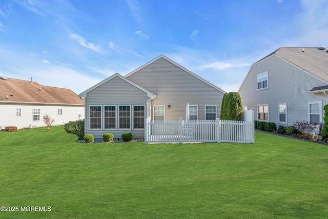 rear view of property with a yard