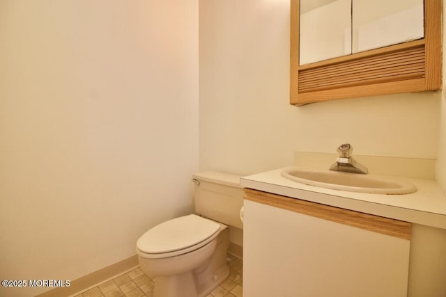 bathroom featuring tile patterned floors, vanity, and toilet