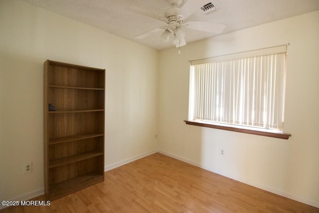 unfurnished room featuring ceiling fan and light wood-type flooring