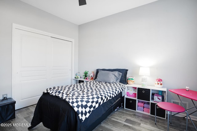 bedroom featuring hardwood / wood-style flooring, a closet, and ceiling fan