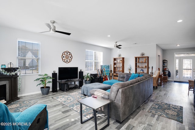 living room with ceiling fan, a healthy amount of sunlight, and wood-type flooring