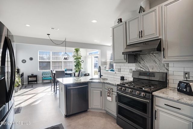 kitchen featuring appliances with stainless steel finishes, sink, pendant lighting, and gray cabinetry