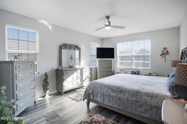 bedroom with ceiling fan, hardwood / wood-style floors, and multiple windows