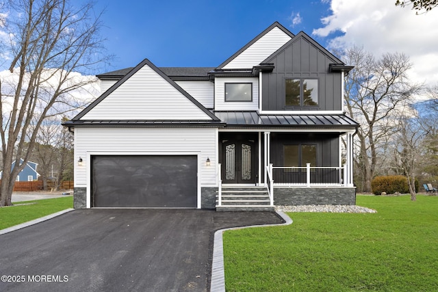 view of front facade featuring a porch, a garage, and a front lawn