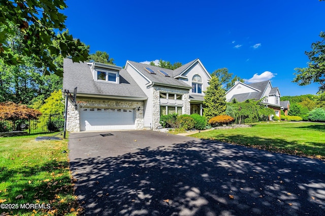 view of front of home featuring a garage and a front lawn