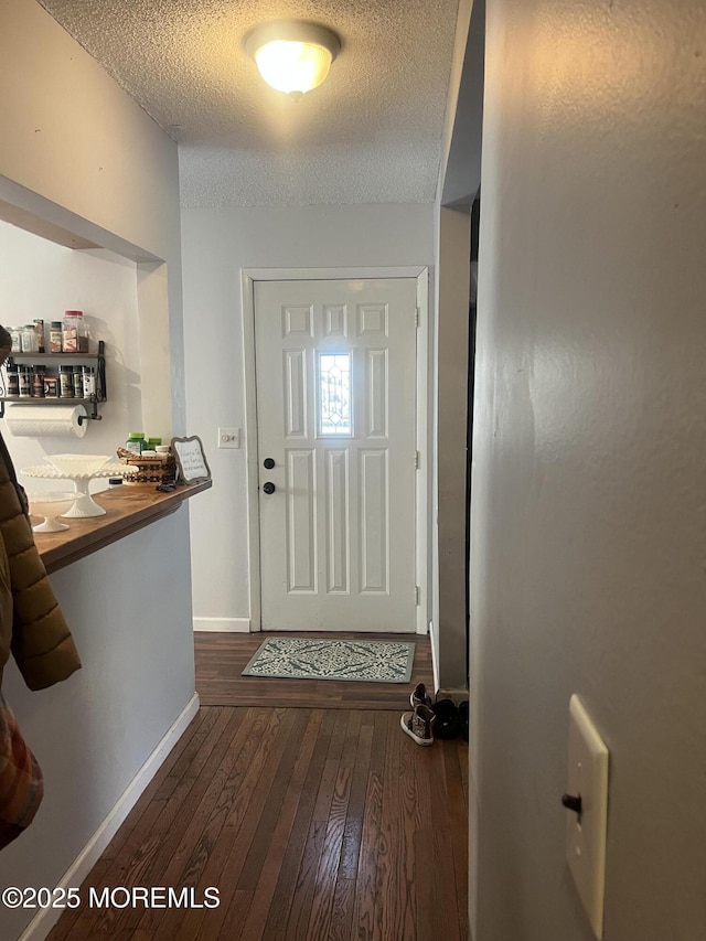 interior space featuring dark hardwood / wood-style flooring and a textured ceiling