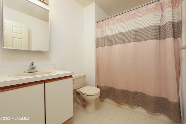 bathroom with vanity, tile patterned floors, a textured ceiling, and toilet