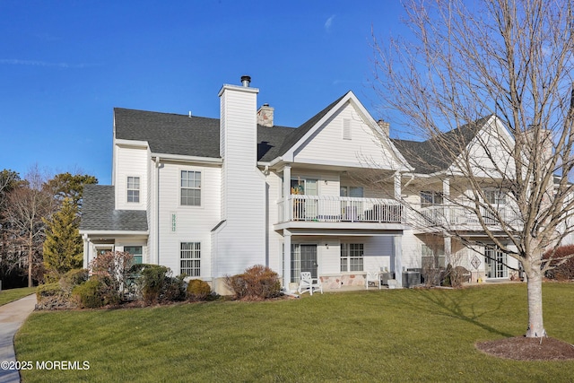 exterior space featuring a yard, central AC, and a balcony