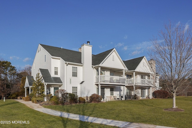 view of front of property with a balcony and a front yard