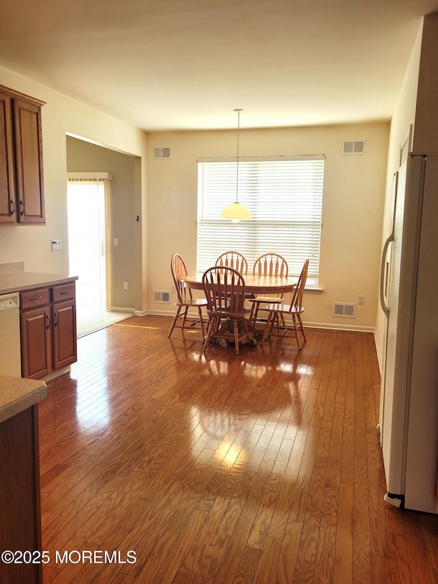 dining area featuring dark wood-type flooring