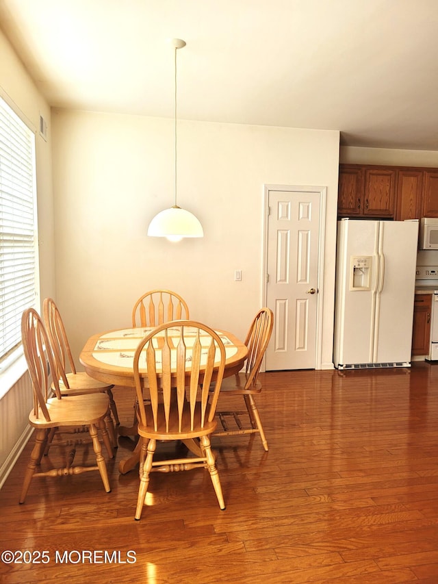 dining room with dark hardwood / wood-style floors