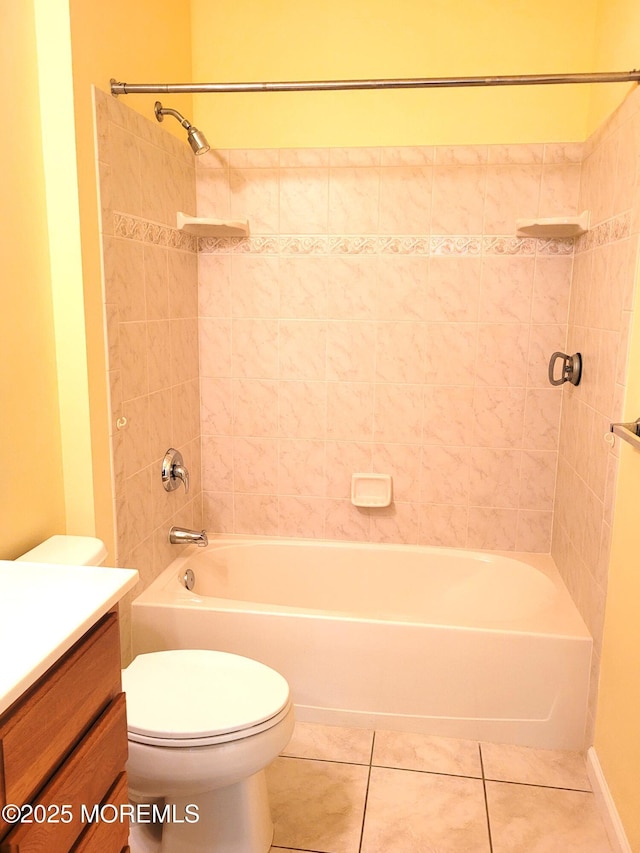 full bathroom featuring vanity, tiled shower / bath combo, tile patterned floors, and toilet