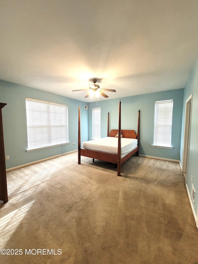 unfurnished bedroom with light colored carpet and ceiling fan