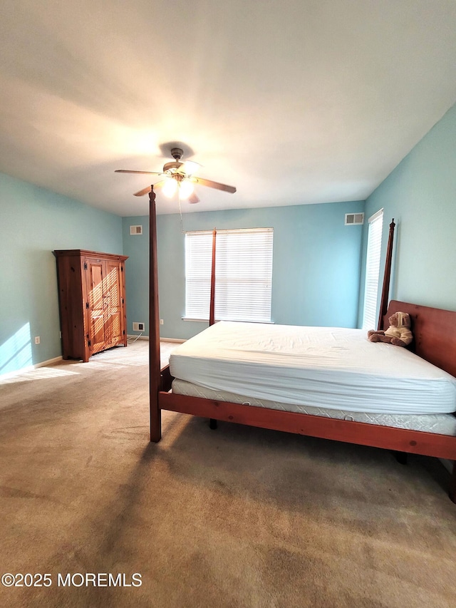 bedroom featuring multiple windows, carpet, and ceiling fan