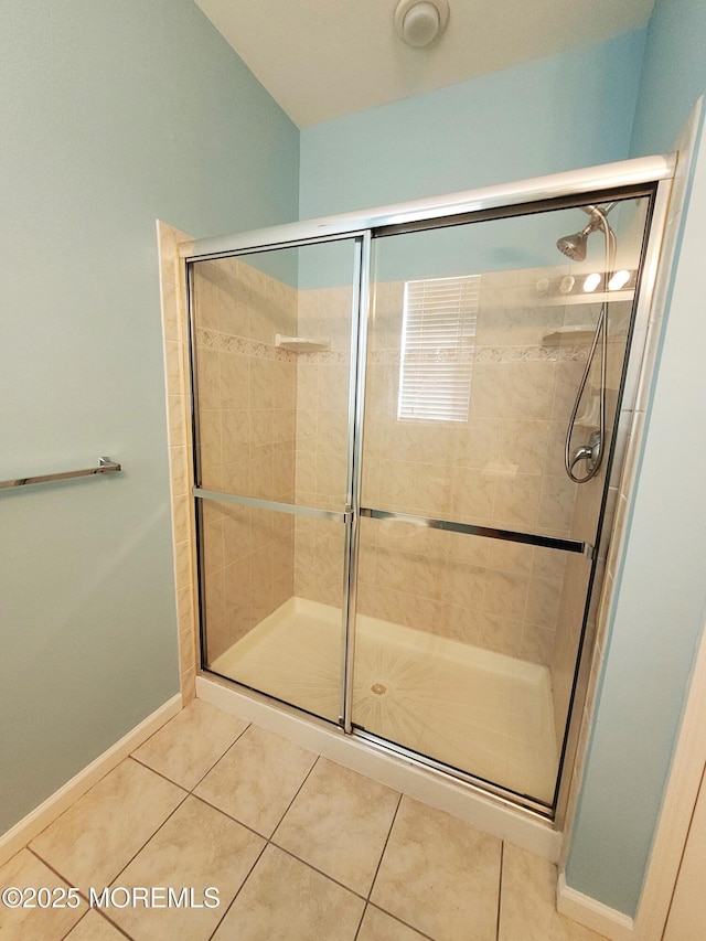 bathroom with tile patterned floors and walk in shower