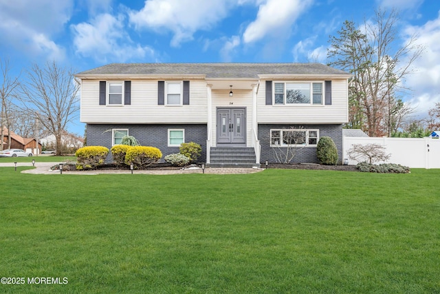 raised ranch featuring a front lawn