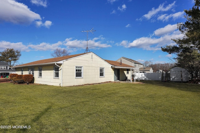 back of house featuring a lawn