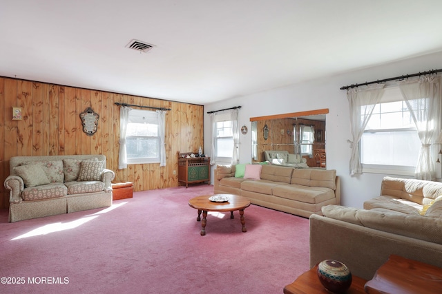 living room with wooden walls and carpet flooring