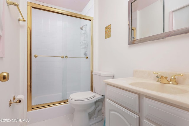 bathroom with tile patterned flooring, vanity, toilet, and a shower with shower door