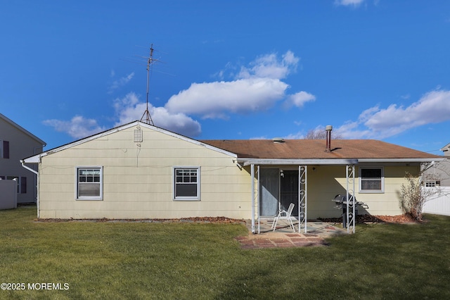 back of property featuring a lawn