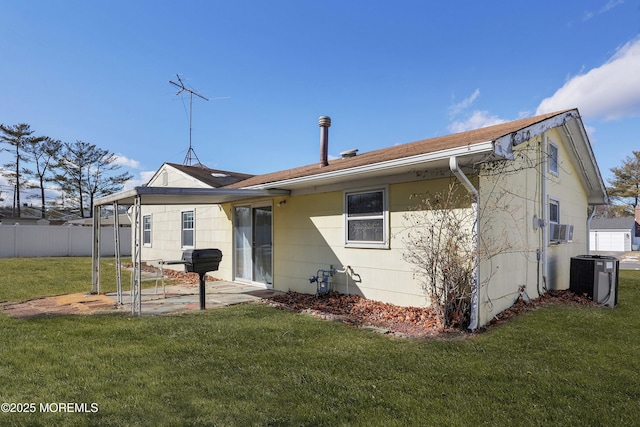 rear view of house with cooling unit, a yard, and central air condition unit