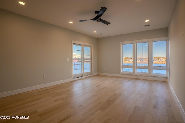 unfurnished room featuring ceiling fan and light hardwood / wood-style floors